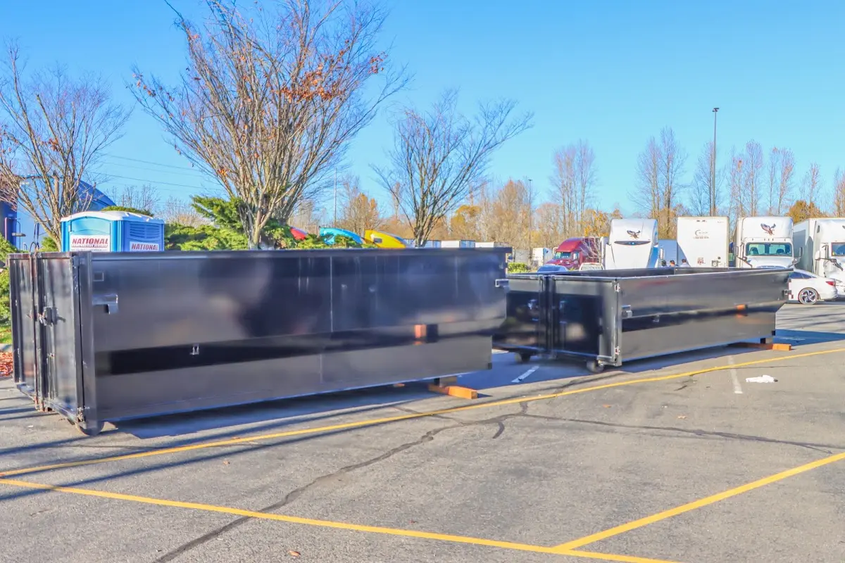 Professional dumpster rental service with roll-off container on residential driveway in New Cumberland